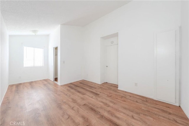 spare room featuring light wood-style flooring