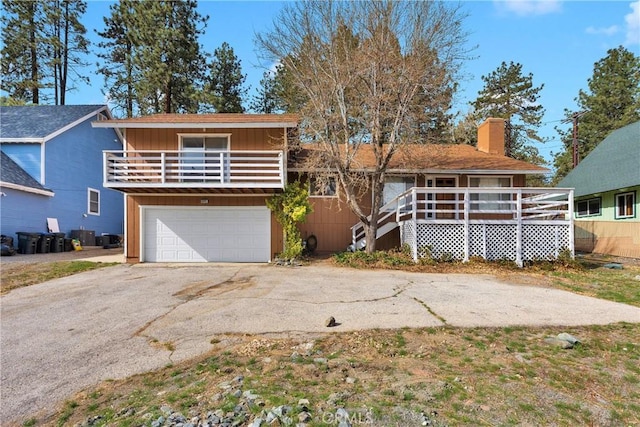 5342 Lone Pine Canyon Rd, Wrightwood, CA 92397 - view of front of home with board and batten siding, a garage, a balcony, a chimney, and driveway