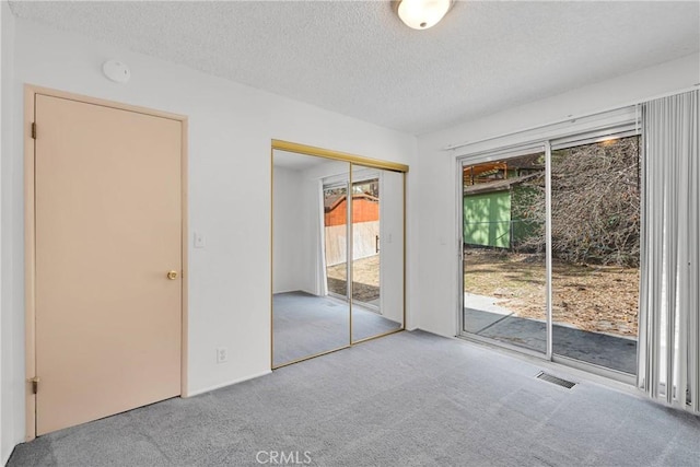 5342 Lone Pine Canyon Rd, Wrightwood, CA 92397 - unfurnished bedroom with carpet floors, access to outside, visible vents, and a textured ceiling