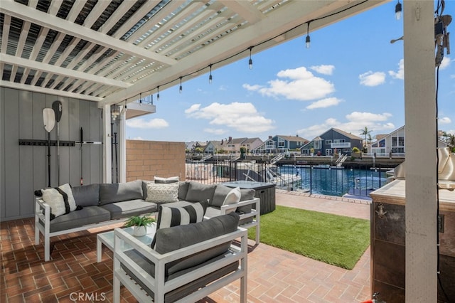 view of patio / terrace with a water view, outdoor lounge area, and a residential view