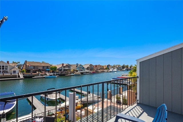 balcony featuring a water view and a residential view