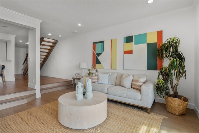 living room with ornamental molding, recessed lighting, wood finished floors, and stairs