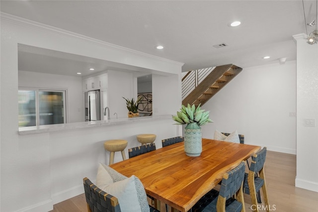 dining room featuring wood finished floors, visible vents, and recessed lighting