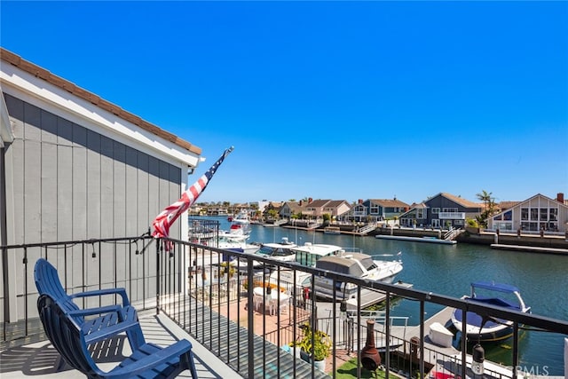 balcony featuring a water view and a residential view