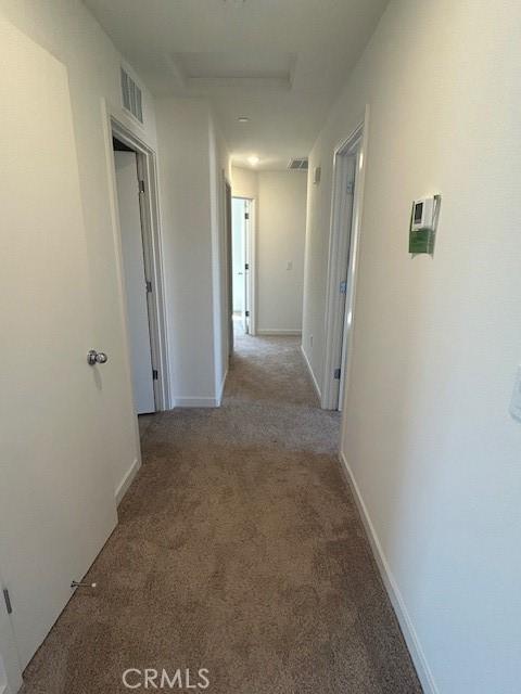771 Brent Ct, Merced, CA 95341 - hall with attic access, carpet floors, and baseboards