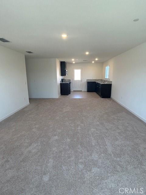 771 Brent Ct, Merced, CA 95341 - unfurnished living room with recessed lighting, light colored carpet, and baseboards