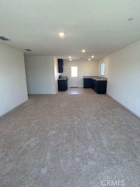 771 Brent Ct, Merced, CA 95341 - unfurnished living room featuring recessed lighting and light colored carpet