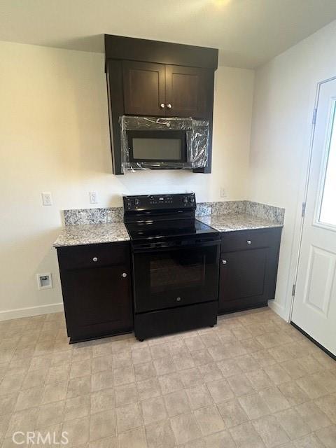 771 Brent Ct, Merced, CA 95341 - kitchen with black appliances, baseboards, light stone countertops, and light floors