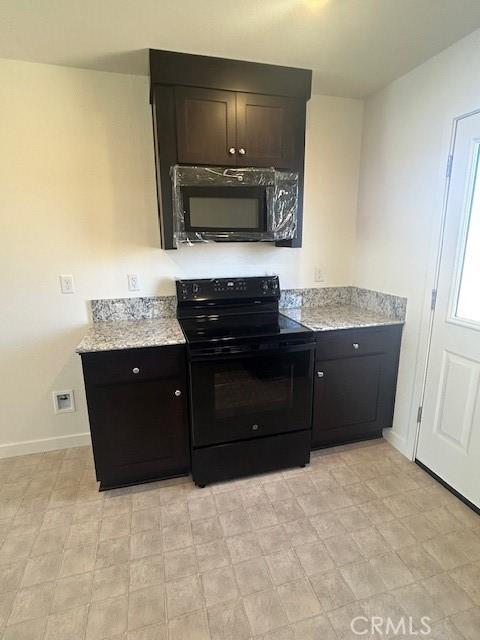 771 Brent Ct, Merced, CA 95341 - kitchen with black appliances and light stone counters