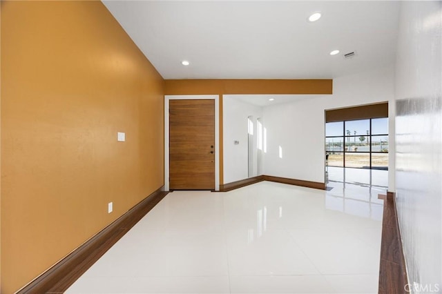 empty room with tile patterned floors, baseboards, recessed lighting, and visible vents
