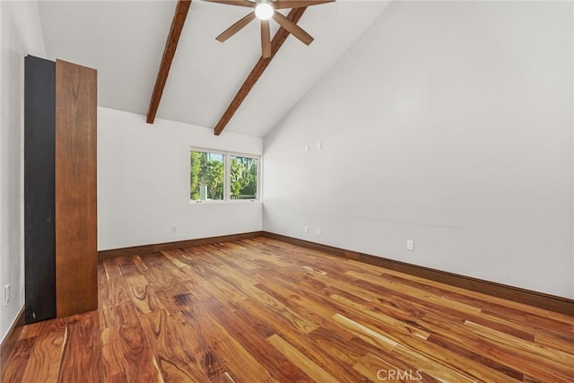 spare room featuring baseboards, a ceiling fan, beamed ceiling, high vaulted ceiling, and wood finished floors