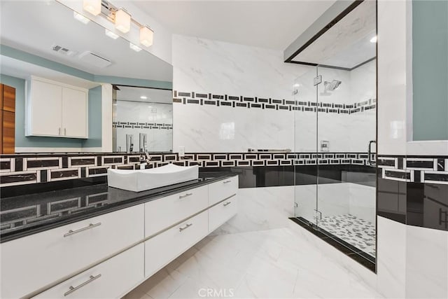 bathroom with vanity, visible vents, marble finish floor, and a stall shower