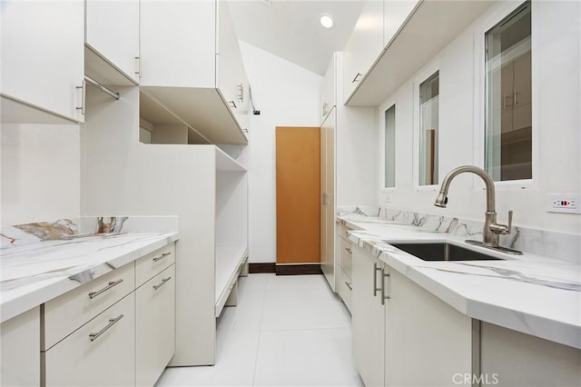 interior space featuring recessed lighting, light tile patterned floors, and a sink