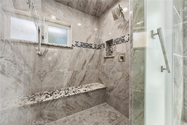 bathroom with tiled shower