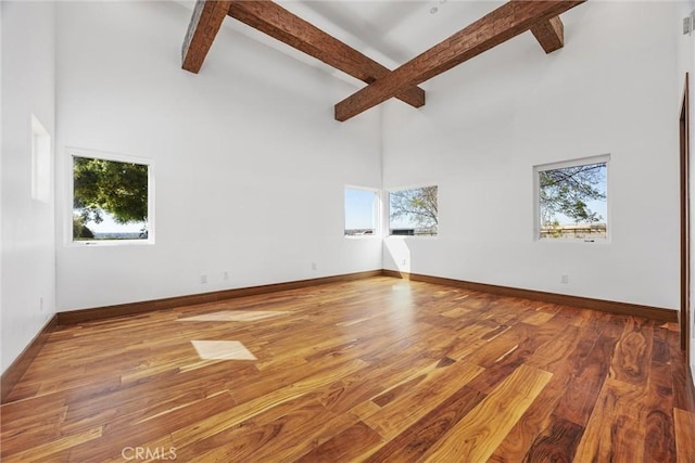spare room with baseboards and a healthy amount of sunlight