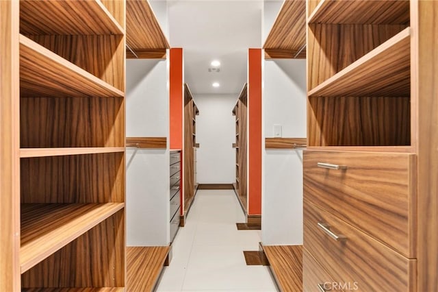 walk in closet with tile patterned floors