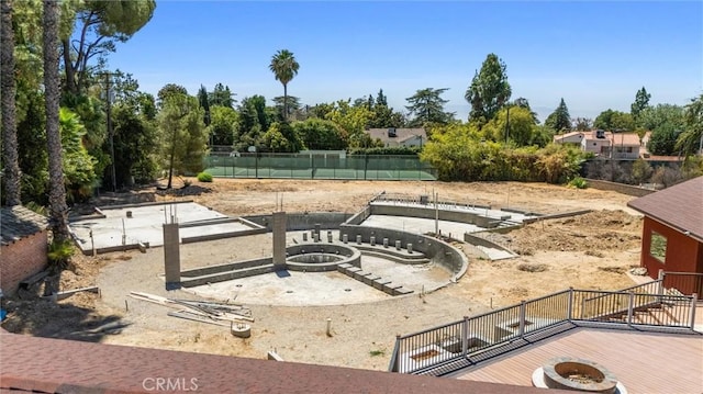 view of yard with an outdoor fire pit and fence