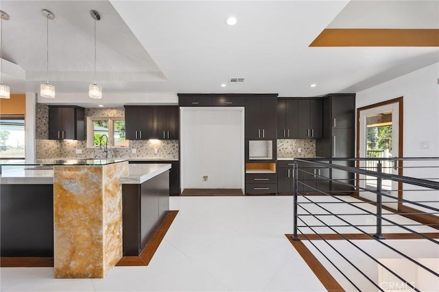 kitchen featuring recessed lighting, light tile patterned floors, backsplash, decorative light fixtures, and visible vents