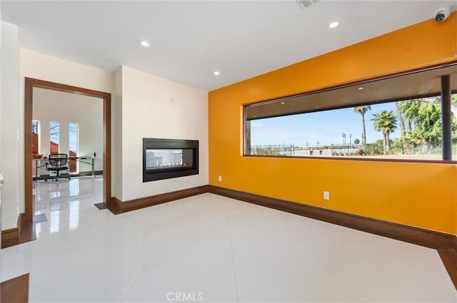 unfurnished living room featuring tile patterned floors, baseboards, a multi sided fireplace, and recessed lighting