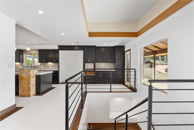 stairs with a wealth of natural light, recessed lighting, and baseboards