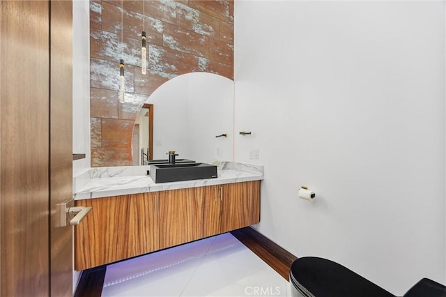 bathroom featuring tile patterned flooring, vanity, and baseboards