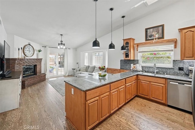 42370 61st St W, Lancaster, CA 93536 - kitchen featuring dishwasher, vaulted ceiling, light wood-style floors, dark stone counters, and healthy amount of natural light