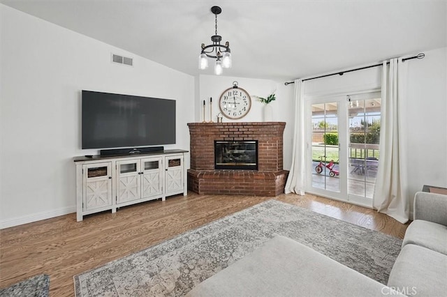 42370 61st St W, Lancaster, CA 93536 - living area with wood finished floors, a chandelier, and a fireplace