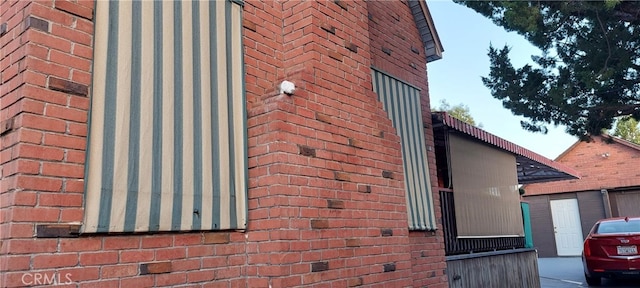 view of side of property featuring brick siding