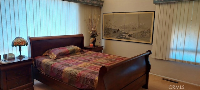 bedroom featuring baseboards, visible vents, and carpet floors