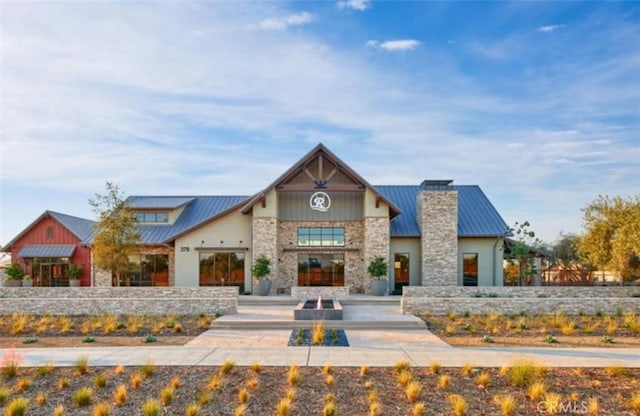 1093 Traverse Dr S, Madera, CA 93636 - view of front of property with a standing seam roof, metal roof, and stone siding