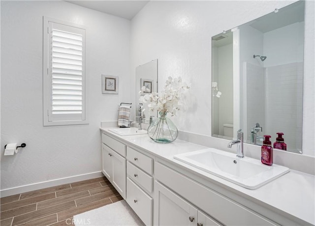 1093 Traverse Dr S, Madera, CA 93636 - full bathroom with baseboards, a sink, wood finished floors, and toilet
