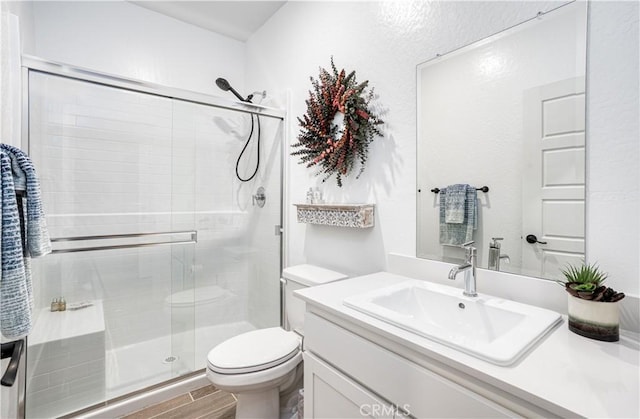 1093 Traverse Dr S, Madera, CA 93636 - bathroom with vanity, a stall shower, toilet, and wood finished floors