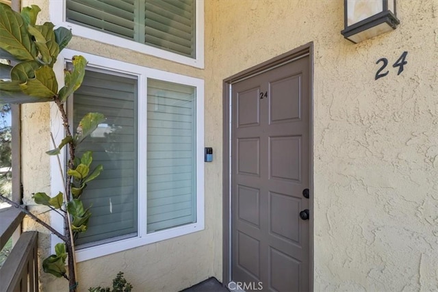 entrance to property with stucco siding
