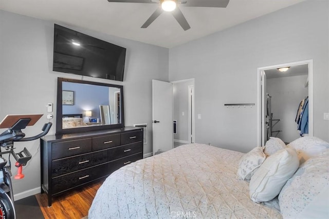 bedroom with wood finished floors, baseboards, and a ceiling fan