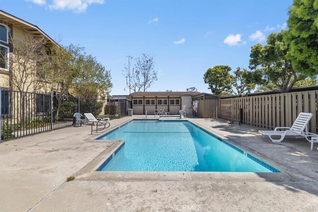 pool featuring fence and a patio