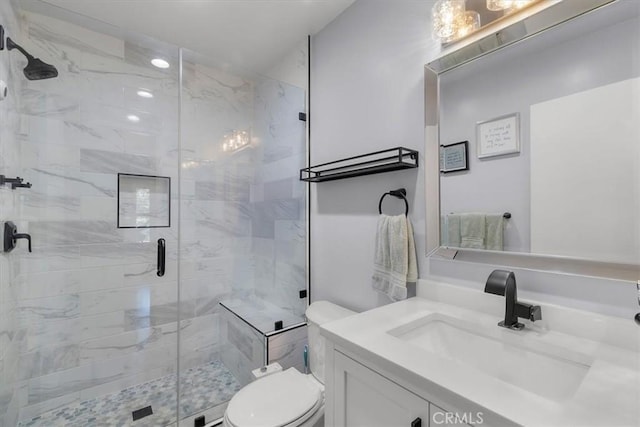 full bathroom with vanity, a stall shower, and toilet