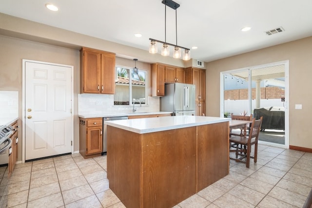 32133 Kale Ln, Winchester, CA 92596 - kitchen with freestanding refrigerator, dishwasher, brown cabinetry, light countertops, and a sink