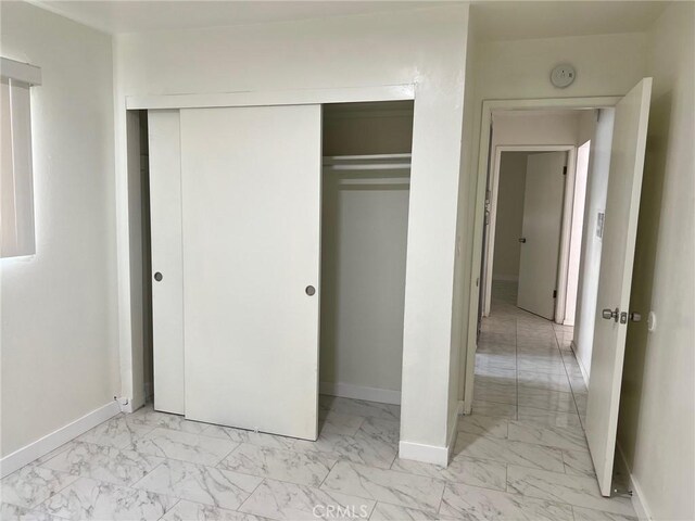 1608 N Placentia Ave, Fullerton, CA 92831 - unfurnished bedroom with marble finish floor, baseboards, and a closet