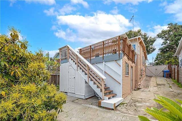 exterior space featuring fence, a gate, and stairs