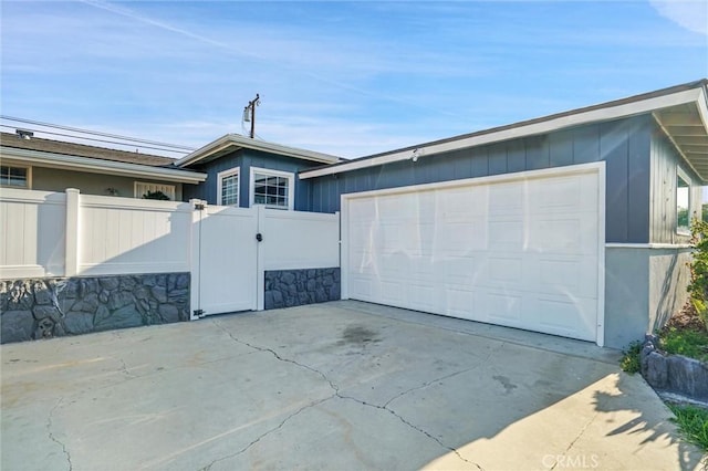 2807 W 129th, Gardena, CA 90248 - garage featuring driveway, fence, and a gate