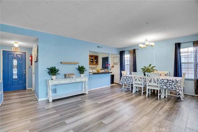 2807 W 129th, Gardena, CA 90248 - dining area with visible vents, a textured ceiling, an inviting chandelier, and wood finished floors