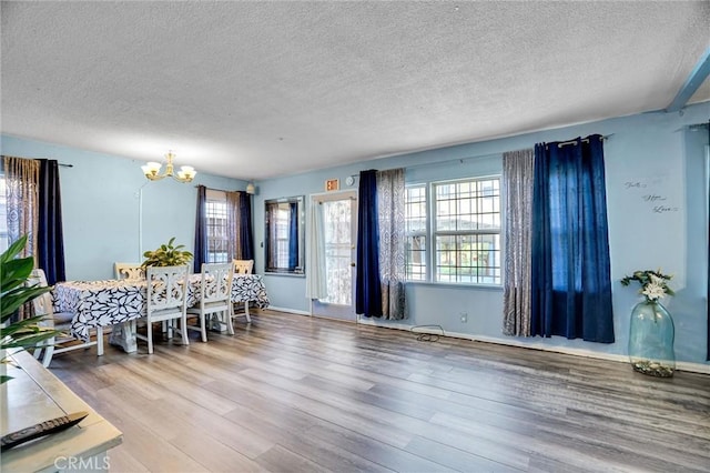 2807 W 129th, Gardena, CA 90248 - dining space with baseboards, a chandelier, wood finished floors, and a textured ceiling