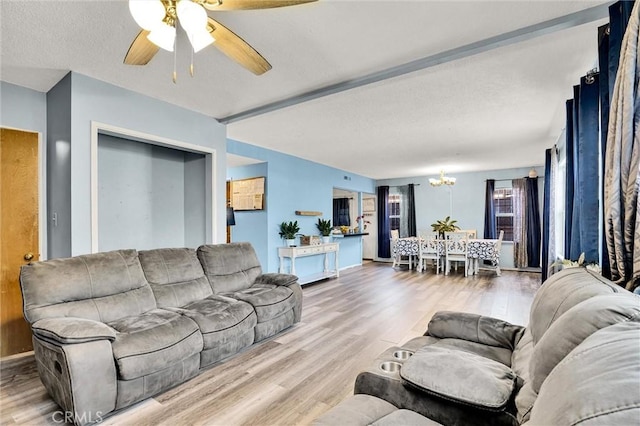 2807 W 129th, Gardena, CA 90248 - living room featuring ceiling fan with notable chandelier, a textured ceiling, and wood finished floors