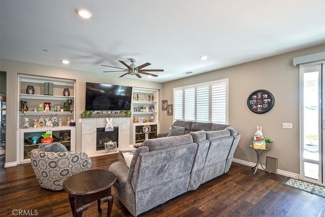 17985 Crabapple Ct, San Bernardino, CA 92407 - living area with a tile fireplace, dark wood-style flooring, a ceiling fan, and a wealth of natural light
