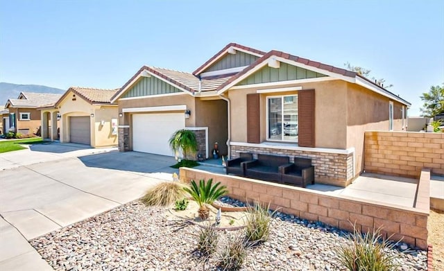 17985 Crabapple Ct, San Bernardino, CA 92407 - view of front of house with an attached garage, stone siding, concrete driveway, a tile roof, and stucco siding