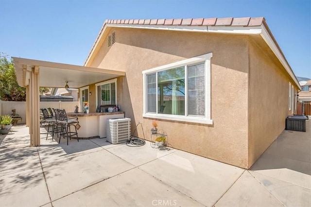 17985 Crabapple Ct, San Bernardino, CA 92407 - rear view of house featuring fence, a patio, outdoor dry bar, central air condition unit, and stucco siding