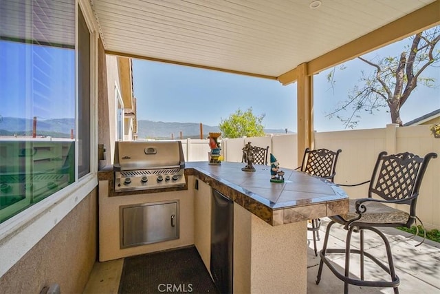 17985 Crabapple Ct, San Bernardino, CA 92407 - view of patio / terrace featuring fence, a grill, outdoor wet bar, and an outdoor kitchen