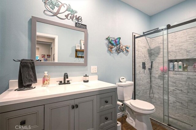 17985 Crabapple Ct, San Bernardino, CA 92407 - bathroom featuring toilet, a shower stall, and vanity