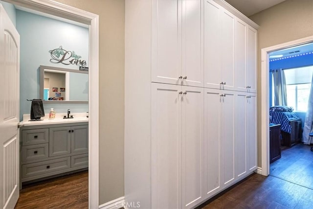 17985 Crabapple Ct, San Bernardino, CA 92407 - hallway with dark wood-style flooring and a sink