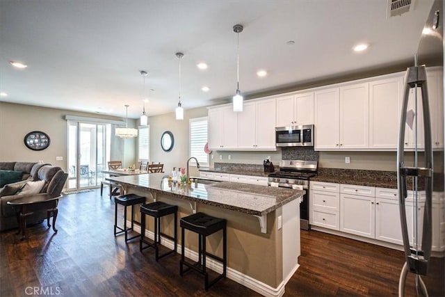 17985 Crabapple Ct, San Bernardino, CA 92407 - kitchen with open floor plan, a wealth of natural light, visible vents, and stainless steel appliances